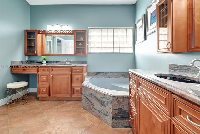 bathroom featuring vanity, tiled bath, and tile patterned flooring