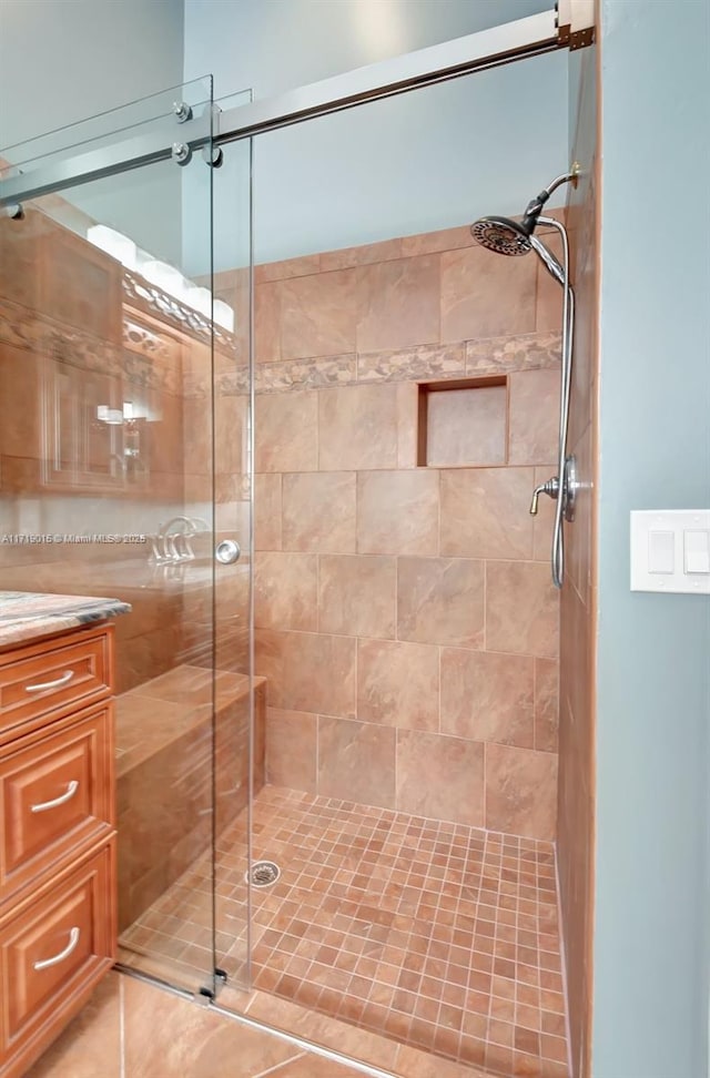 bathroom featuring vanity and a shower with shower door