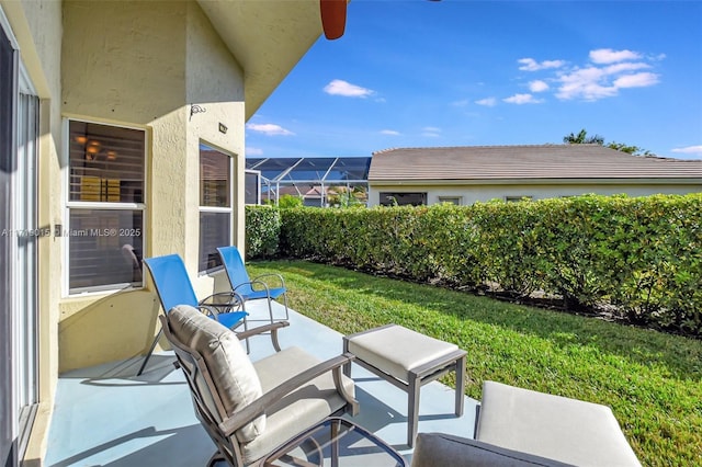 view of patio / terrace featuring a lanai