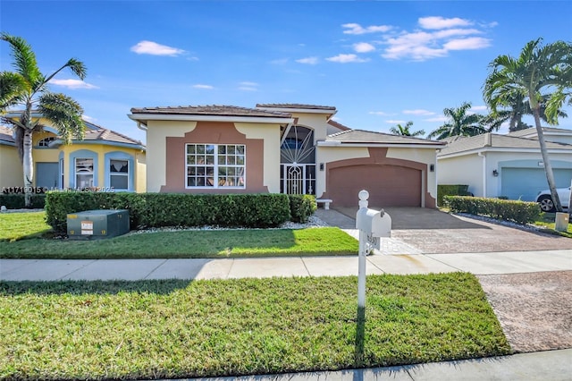 view of front of property with a garage and a front lawn