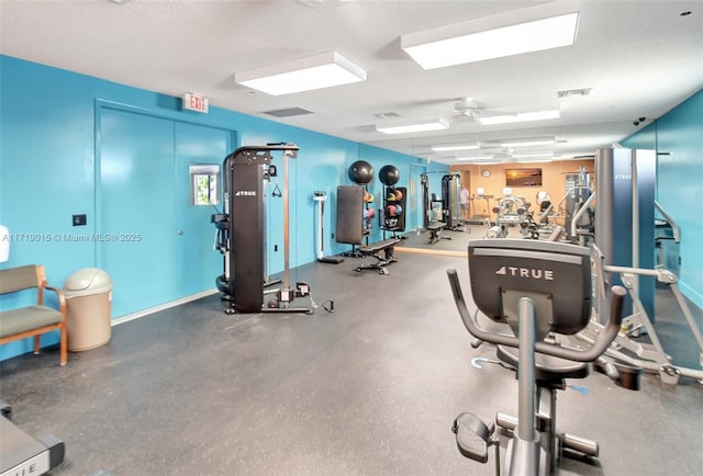 exercise room featuring a textured ceiling