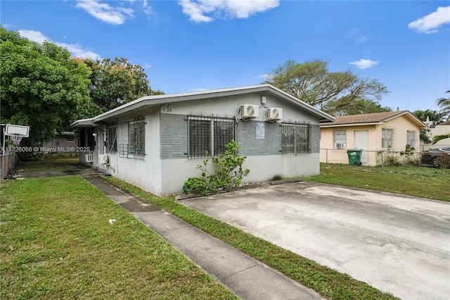 view of side of home with a lawn and a patio