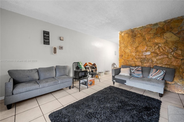 tiled living room featuring a textured ceiling