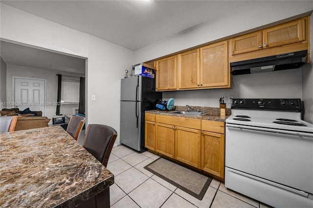 kitchen with white range with electric stovetop, light tile patterned floors, stainless steel fridge, and sink