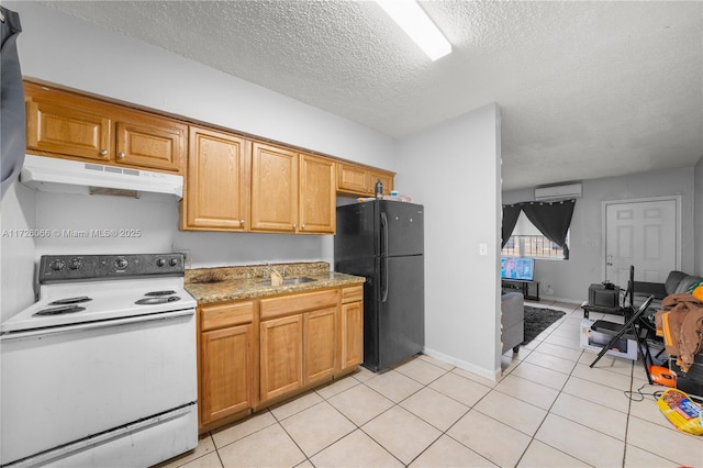 kitchen featuring an AC wall unit, white range with electric stovetop, sink, a textured ceiling, and black refrigerator