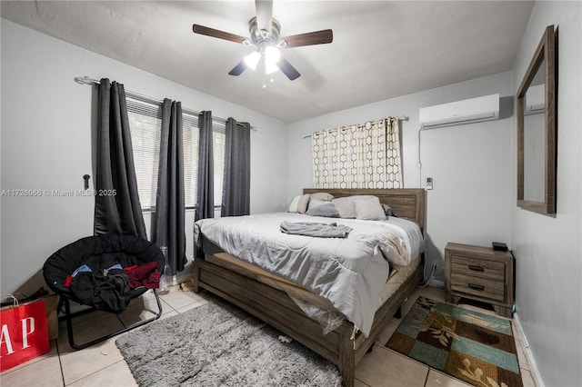 bedroom with ceiling fan, light tile patterned floors, and a wall mounted air conditioner