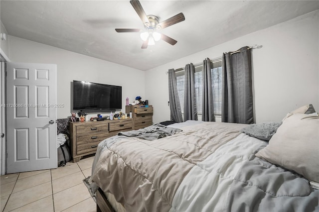 bedroom featuring ceiling fan, light tile patterned floors, and vaulted ceiling