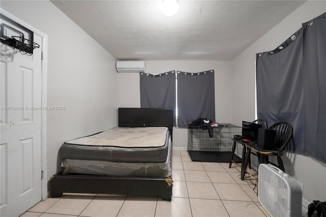 bedroom with light tile patterned floors and a wall mounted air conditioner