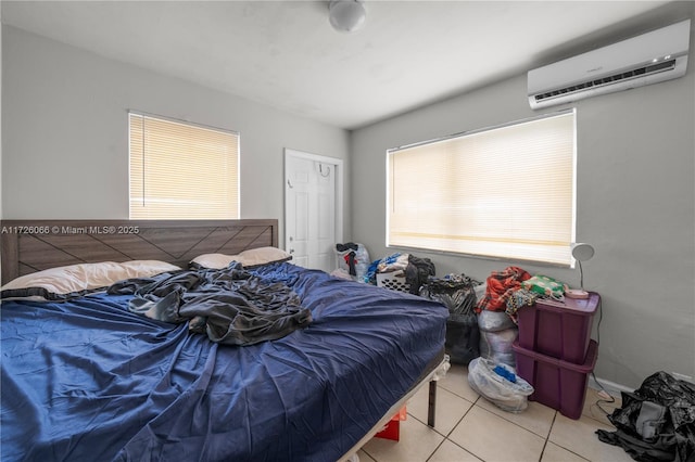 tiled bedroom featuring a wall mounted air conditioner