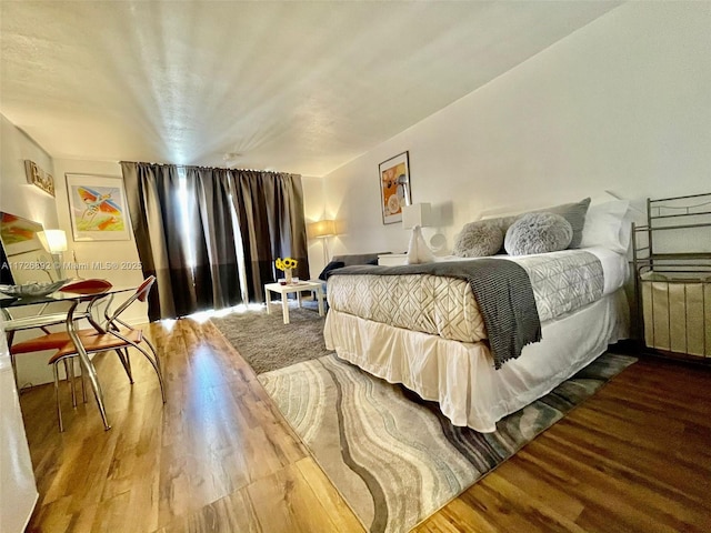 bedroom with radiator and wood-type flooring