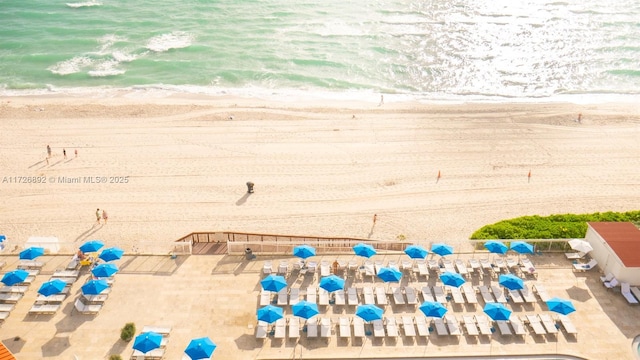 birds eye view of property featuring a beach view and a water view