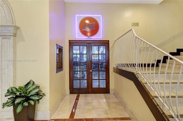 foyer entrance with french doors and a high ceiling