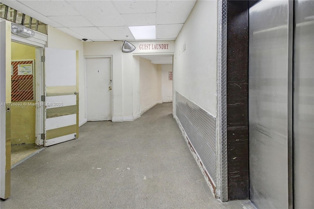 corridor featuring a paneled ceiling