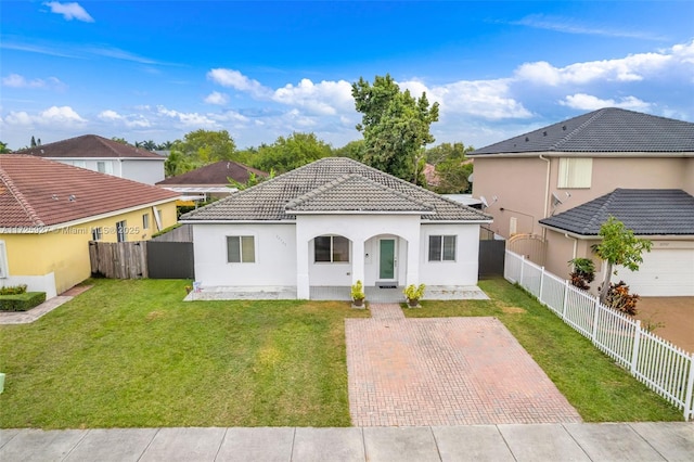 mediterranean / spanish home featuring a front lawn