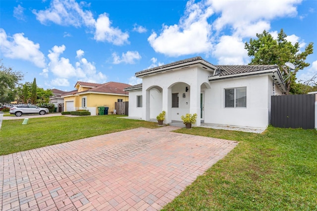 mediterranean / spanish-style home featuring a front lawn