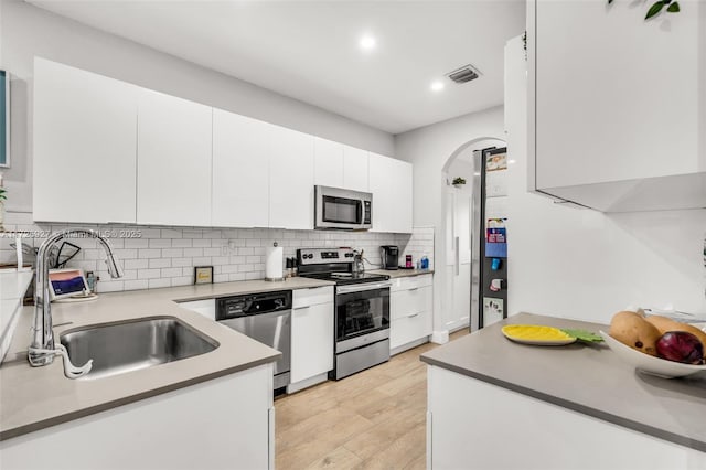 kitchen featuring white cabinets, light wood-type flooring, sink, and stainless steel appliances