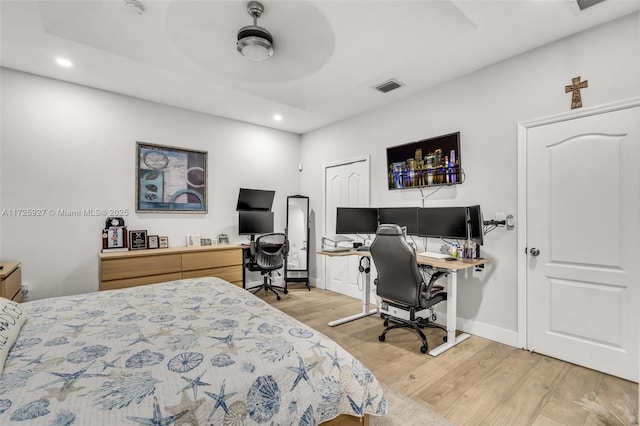 bedroom with light hardwood / wood-style floors and ceiling fan