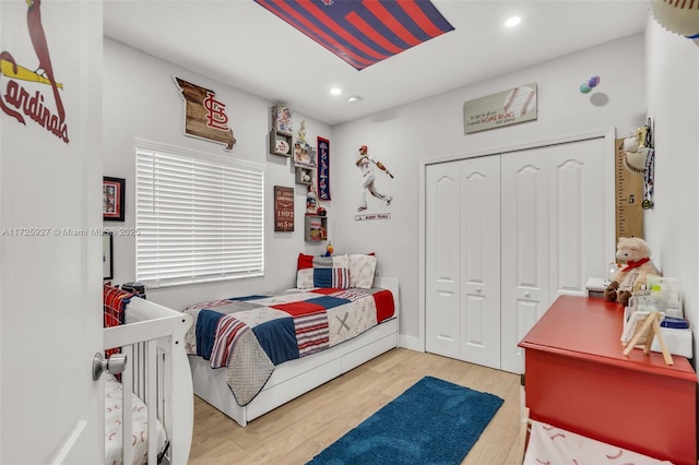 bedroom with a closet and hardwood / wood-style floors