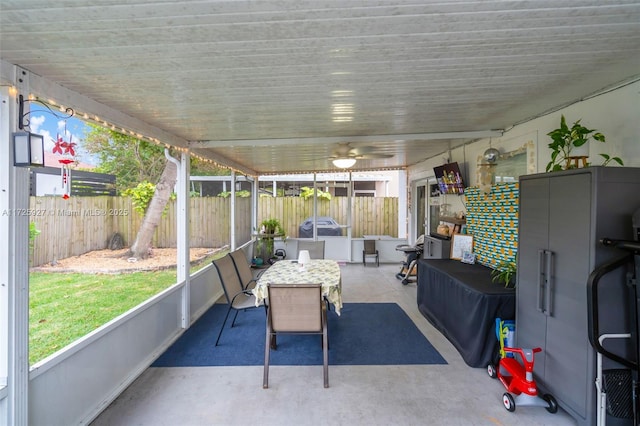 sunroom featuring ceiling fan