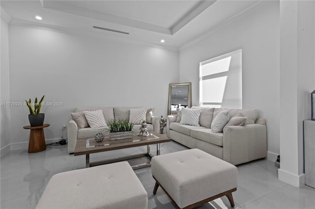 living room featuring crown molding and a tray ceiling