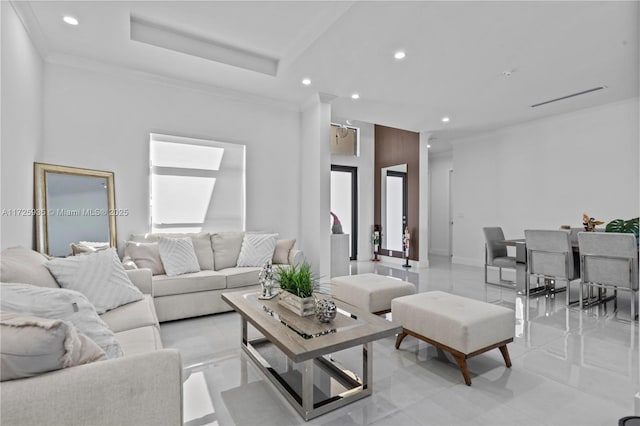 living room with a tray ceiling and crown molding