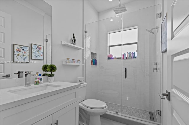 bathroom with toilet, vanity, and walk in shower