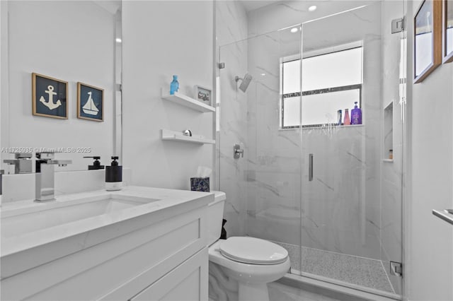 bathroom with toilet, an enclosed shower, and vanity