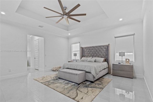 bedroom featuring a raised ceiling, ceiling fan, and ornamental molding