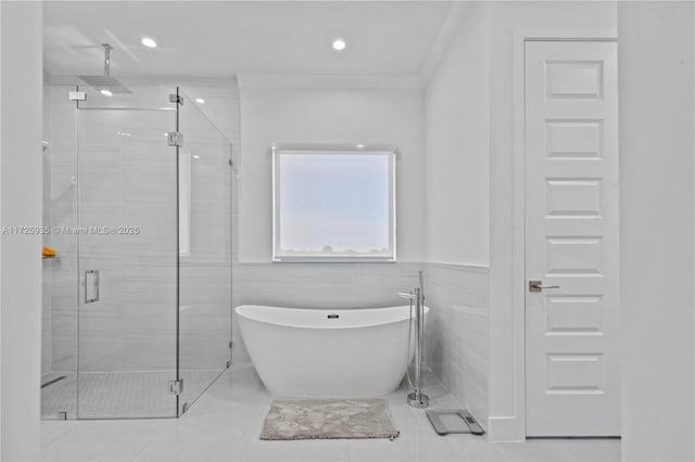 bathroom with separate shower and tub, tile walls, and tile patterned floors