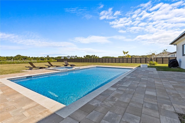 view of swimming pool featuring a patio area and a yard