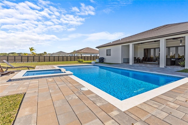 view of pool with ceiling fan, an in ground hot tub, and a patio