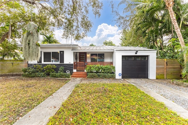 view of front facade with a front yard and a garage