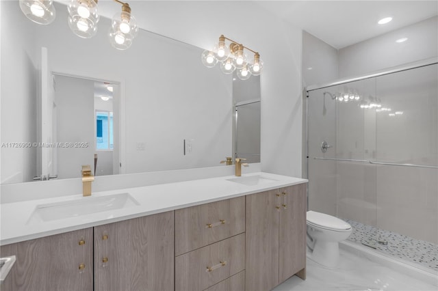 bathroom with a shower with shower door, toilet, and vanity