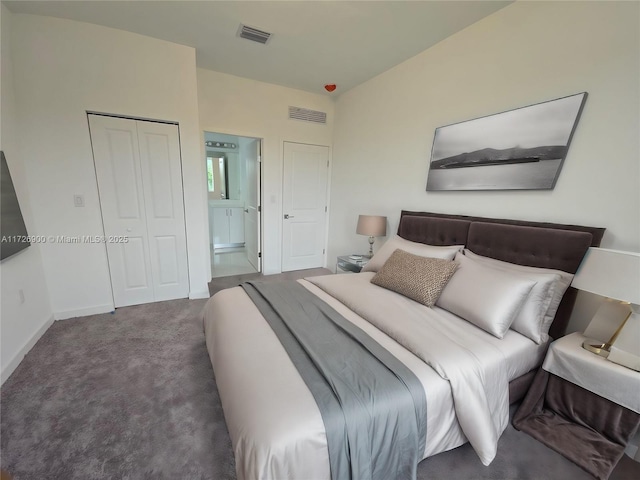 carpeted bedroom featuring a closet and ensuite bathroom