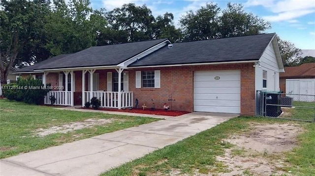 ranch-style house with a garage, a front yard, and covered porch