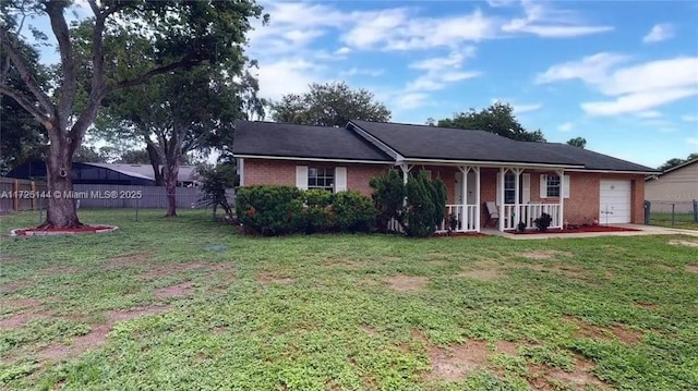 ranch-style house featuring a front lawn, a porch, and a garage