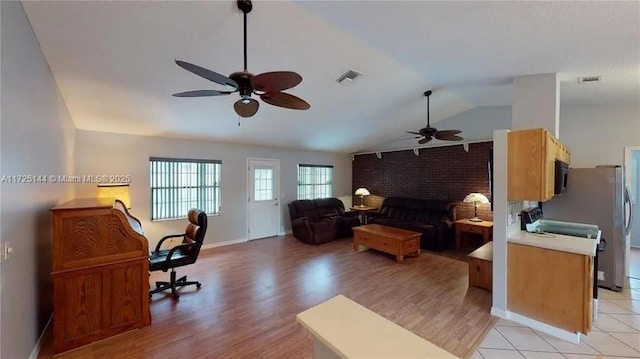 home office featuring vaulted ceiling, ceiling fan, and light hardwood / wood-style floors