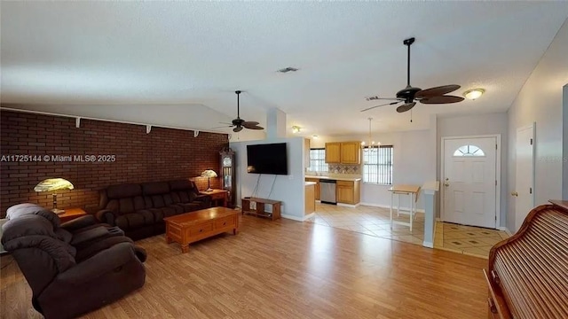 living room with vaulted ceiling, ceiling fan, and light hardwood / wood-style floors