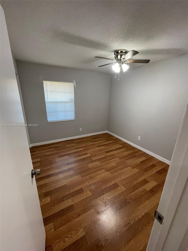 unfurnished room with ceiling fan, a textured ceiling, and hardwood / wood-style flooring