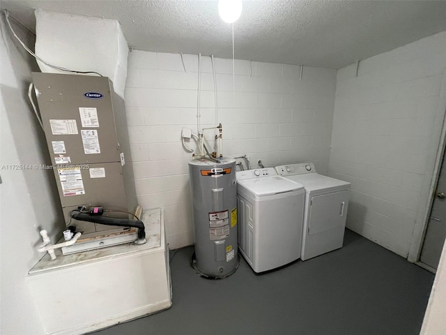 clothes washing area featuring washer and dryer, a textured ceiling, electric water heater, and heating unit