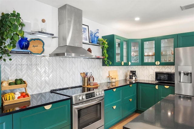 kitchen with backsplash, island range hood, stainless steel appliances, and green cabinets