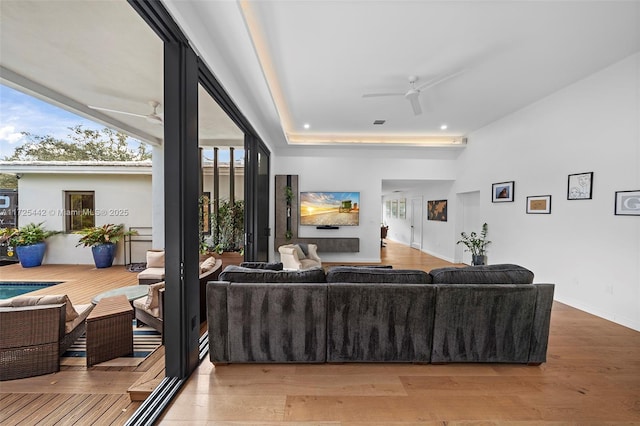 living room featuring ceiling fan and wood-type flooring