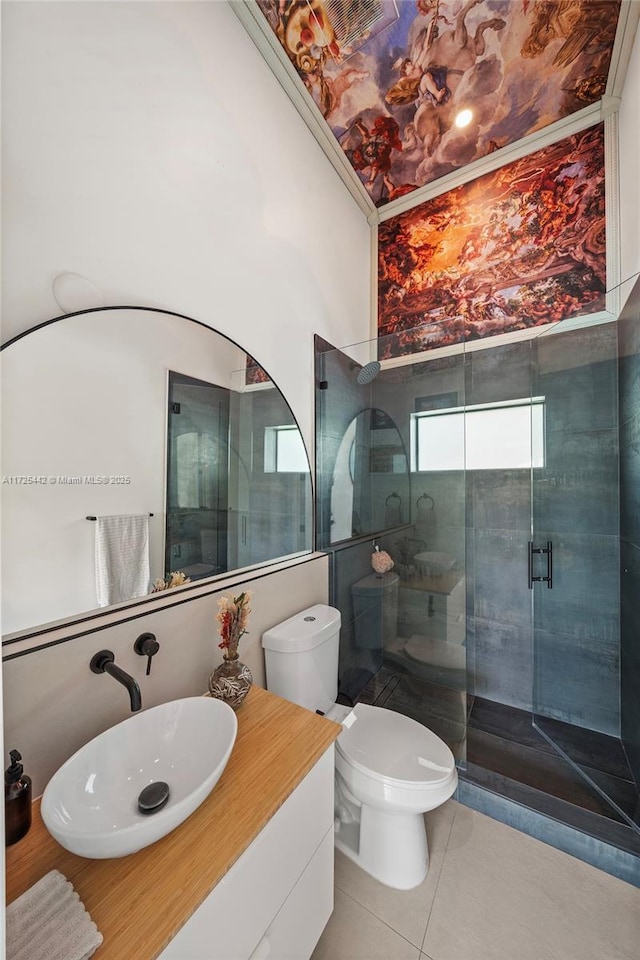 bathroom with toilet, tile patterned flooring, walk in shower, crown molding, and vanity