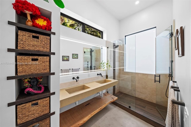 bathroom with concrete floors, an enclosed shower, and vanity