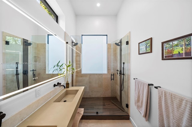 bathroom featuring walk in shower and vanity