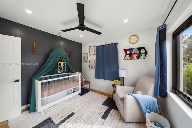 bedroom with ceiling fan and light hardwood / wood-style floors