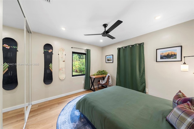 bedroom with ceiling fan and light hardwood / wood-style flooring