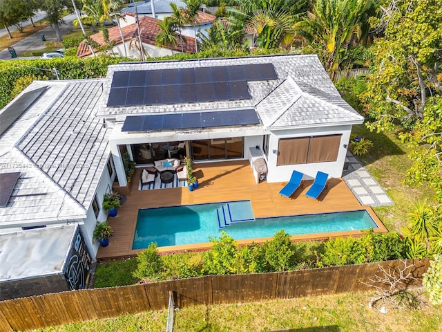 exterior space with a wooden deck and solar panels