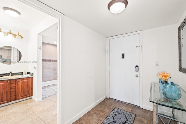 foyer with light tile patterned flooring and sink