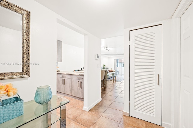 hall featuring light tile patterned flooring